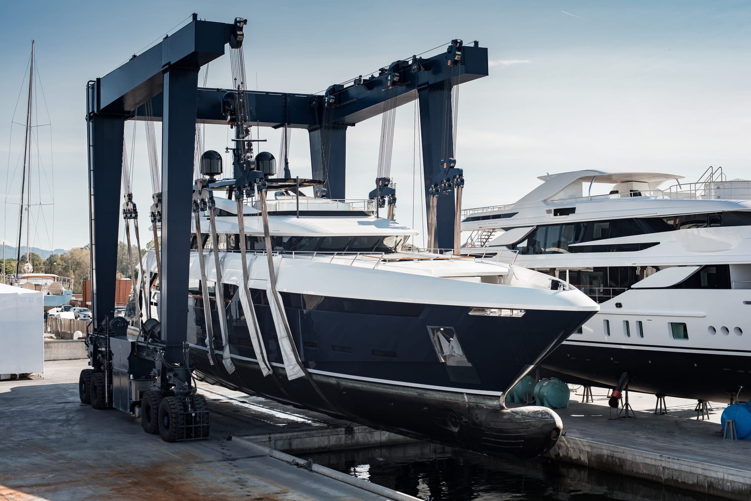 Superyacht being lifted at a shipyard